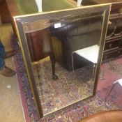 A square mirror bevelled plate ebonised frame with gilt edge
