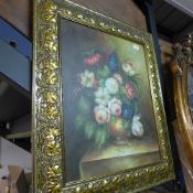 An oil on canvas still life of flowers in gilt frame