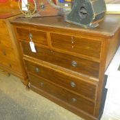An Edwardian mahogany inlaid chest having two short above three long drawers on plinth base
