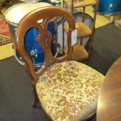 A pair of mahogany spoonback chairs upholstered floral pad seat