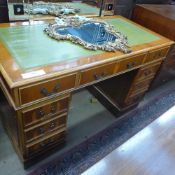 A yewood pedestal desk the tooled leather top above drawers
