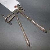 A pair of continental silver knife rests together with a French nut cracker