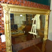 A Victorian carved giltwood wall mirror/overmantel the rectangular plate flanked by lion mask relief