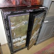 A black lacquered cabinet Geisha decoration on two panel doors