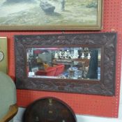 An Oriental needlework arrangement and carved mirror and bagatelle board