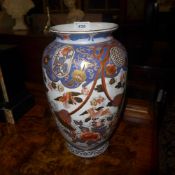 A pair of Imari palette porcelain vases with pictorial panels
