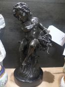 A bronze style model of a young boy on circular marble base