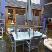 A grey painted garden set comprising glass top table, six chairs and parasol