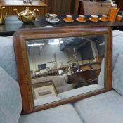 A Victorian walnut overmantel mirror with arched plate