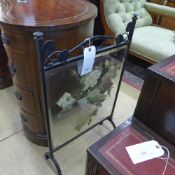 An Arts and Crafts wrought iron and mirrored fire screen with painted detail