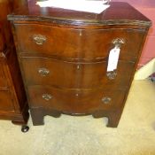 An early C20th walnut chest having three graduated drawers on bracket feet