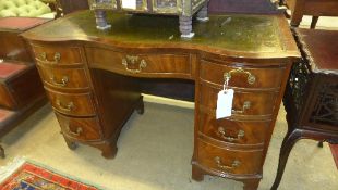 A C20th mahogany desk the tooled leather top above drawers on bracket feet