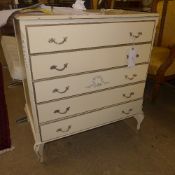 A white painted chest having five graduated drawers