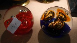 Two art glass paperweights both decorated with bubbles