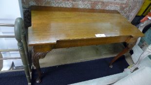A George III style console table the shaped top raised on carved pad foot