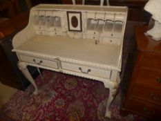 A distress painted Carlton house design desk with an arrangement of drawers and pigeon holes on ball
