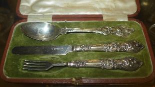 A Victorian hallmarked sterling silver cased christening set with neo Rococo handles