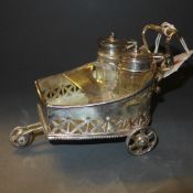 A silver plated cruet in the form of a cart
