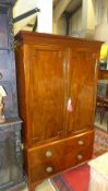 A George III mahogany linen press of shallow proportions, the panel doors enclosing hanging space/
