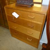 A pair of oak G-plan chests one with secretaire drawers on plinth bases