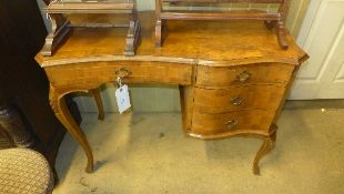 A C19th Italian walnut writing table the shaped top above drawers on cabriole supports