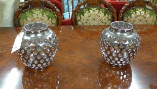 A pair of silvered porcelain reticulated pot pourri vases