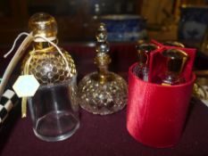 Two gold overlay glass perfume bottles in fabric case