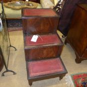 An antique mahogany set of library steps with leather inset tiers
