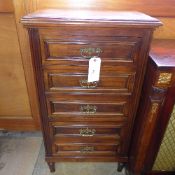 A C20th walnut continental five drawer chest with brass handles on turned feet