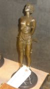 A bronzed figure of a girl with a whip