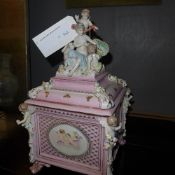 A porcelain casket with cherub decoration
