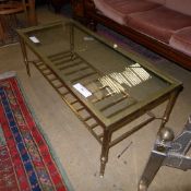 A C20th brass glass top low table united by slatted undertier