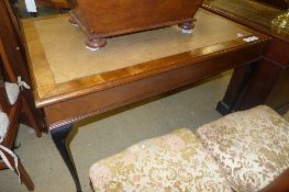A C20th walnut library table the leatherette inset top raised on cabriole supports