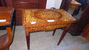 A profusely carved inlaid card table on tapered supports