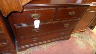 A late Victorian walnut chest having two short above two long drawers