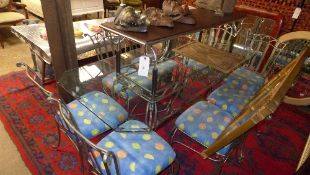 A wrought iron glass conservatory table with eight matching chairs