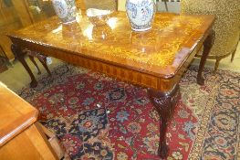 A large Dutch design marquetry inlaid large dining table raised on carved cabriole supports