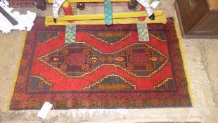 A Persian type small rug the red ground with central motifs