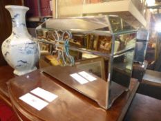 A mirrored jewellery box with lined interior