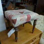 A Victorian mahogany stool with pad seat on turned supports