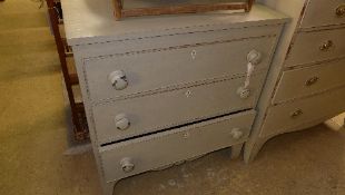 A grey painted chest having three drawers with knob handles on bracket feet W 85 D 46 H 90 cm