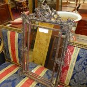 A gesso style pier mirror in the rococo manner