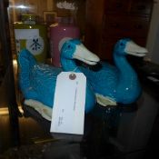 A pair of ceramic blue ducks