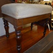 A Victorian mahogany footstool with pad seat on turned support