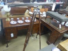 A silver plated telescope on stand