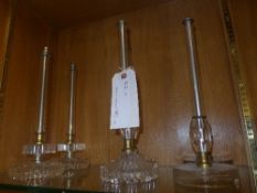 A set of three pairs of glass and metal stick candlesticks