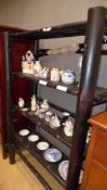 An ebonised three tiered bamboo bookcase with open shelves