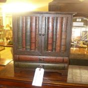 A table top cabinet in the form of book spines