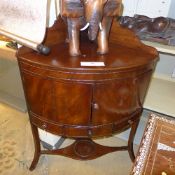 A late Georgian mahogany corner washstand with cupboards and drawers on slender support