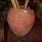 A large terracotta garden pot with sgraffito pattern and four carrying handles